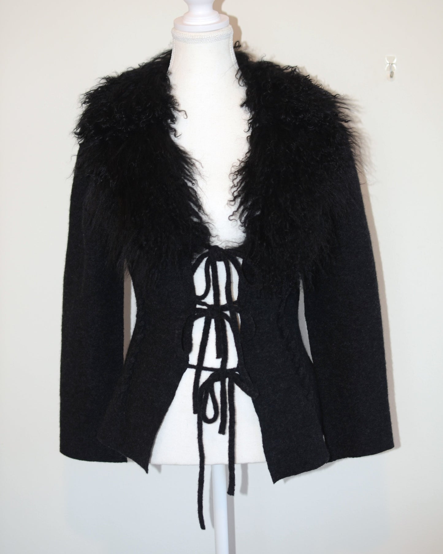 Black Roberto Cavalli jacket with faux fur  trim on a mannequin against a white background