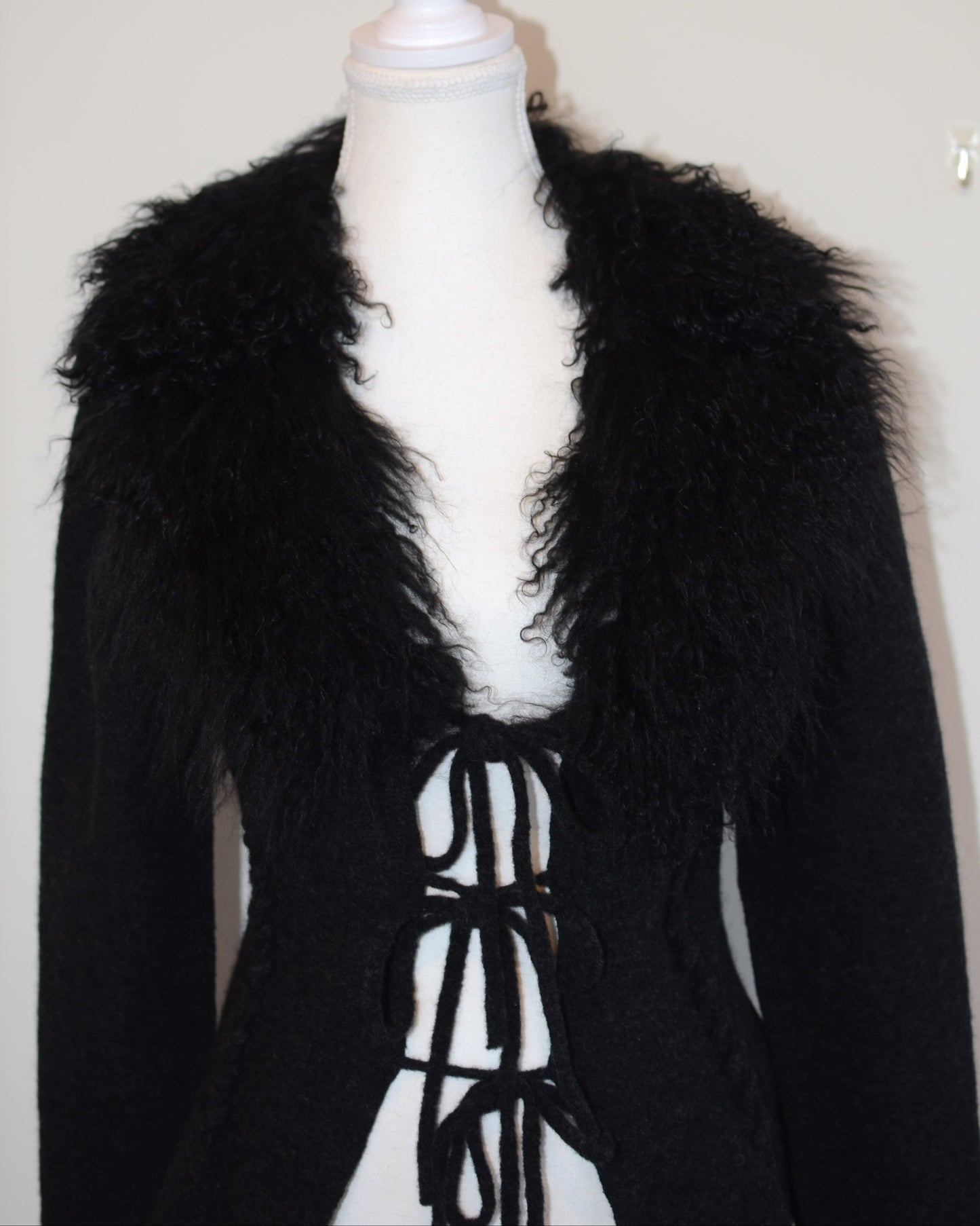 Black Roberto Cavalli jacket with faux fur  trim on a mannequin against a white background